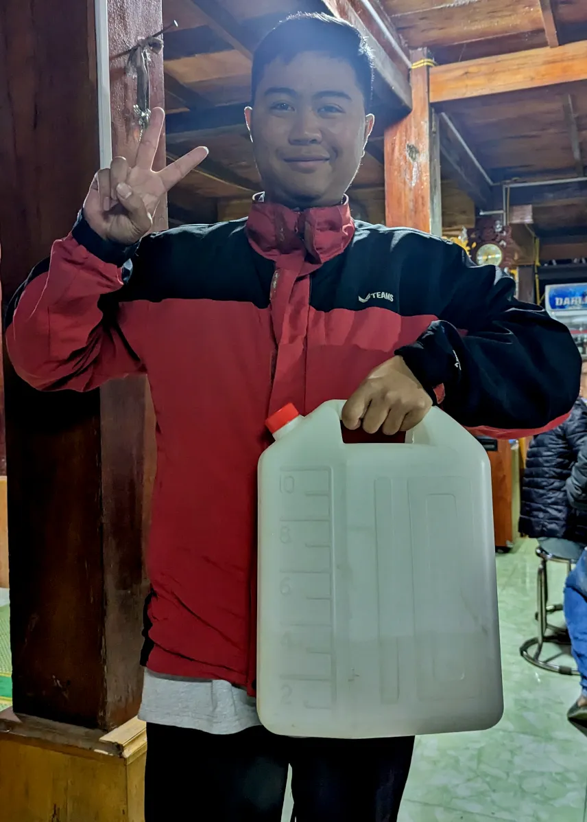 Picture of Our tour guide with a whole canister of happy water