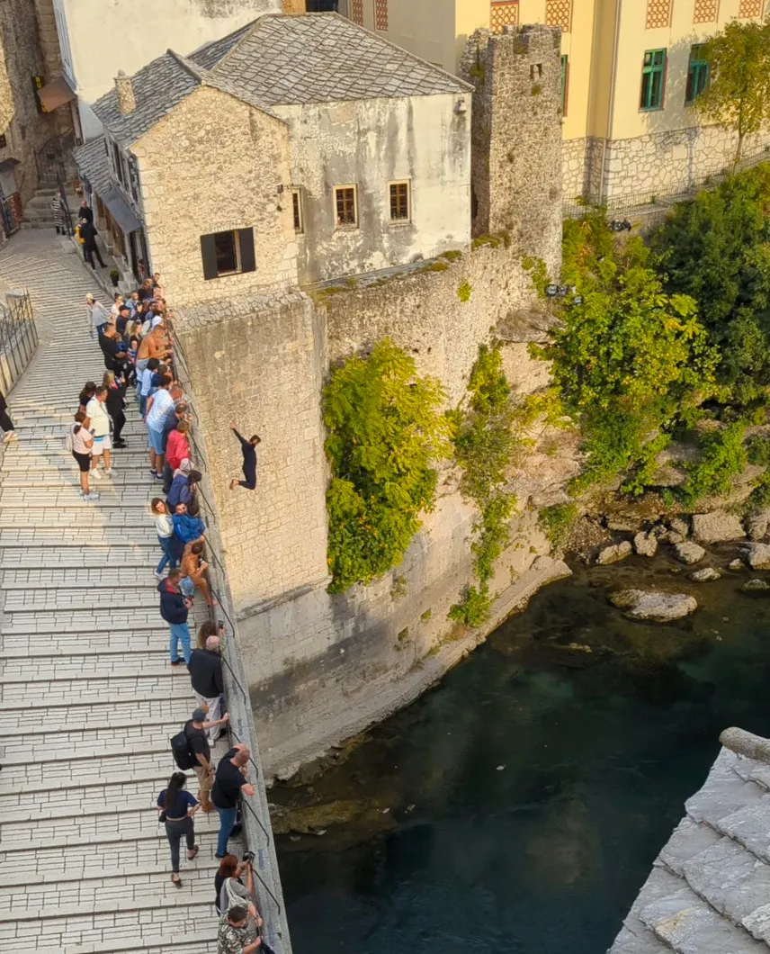 Person jumping off the Old Bridge